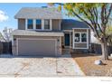 Charming two-story home with a gray exterior, a two-car garage, and a well-maintained front yard at 10579 Cherry St, Thornton, CO 80233