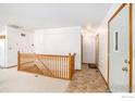 Spacious entryway featuring staircase, tile flooring, and natural light at 1130 Navajo Pl, Berthoud, CO 80513