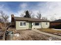 House exterior with a green facade, landscaping, and a gravel driveway at 1148 Gay St, Longmont, CO 80501