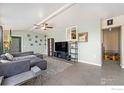 Bright living room featuring a sectional sofa and a large TV at 1373 E 110Th Pl, Northglenn, CO 80233