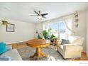 Inviting living room features hardwood floors, a ceiling fan and a sun-filled window at 1373 E 110Th Pl, Northglenn, CO 80233