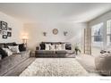 Bright living room featuring neutral colors and a ladder by the window at 13900 Lake Song Ln # 2, Broomfield, CO 80023