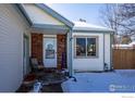 Inviting front porch with brick accents and winter decor at 1621 Flemming Dr, Longmont, CO 80501