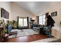 Bright living room featuring hardwood floors, large windows and comfy seating at 1621 Flemming Dr, Longmont, CO 80501