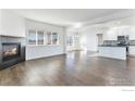 Open concept kitchen with white cabinets, an island, and hardwood floors at 16636 W 94Th Dr, Arvada, CO 80007