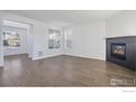 Spacious living room with hardwood floors and a modern fireplace at 16636 W 94Th Dr, Arvada, CO 80007