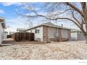 Rear exterior view of a well-maintained home with a fenced backyard and gravel landscaping at 2027 Terry St # 1, Longmont, CO 80501