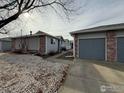 Rear view of duplex showing garage and landscaping at 2027 Terry St # 1, Longmont, CO 80501