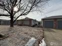 Side view of duplex with tree and gravel landscaping at 2027 Terry St # 1, Longmont, CO 80501