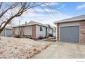 View of a house with a one-car garage and well kept grounds at 2027 Terry St # 1, Longmont, CO 80501