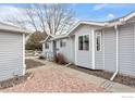 Side view of cozy single-story property with gray siding and stone landscaping at 2027 Terry St # 1, Longmont, CO 80501