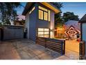 Modern gray garage with a wooden fence and mural at 2345 South St, Boulder, CO 80302