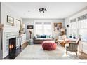 Bright living room with fireplace, neutral walls, large windows and stylish furnishings at 2424 4Th St, Boulder, CO 80304