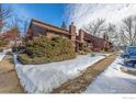 Exterior view of a brown multi-unit building with landscaping and snow at 2640 Juniper Ave # 2, Boulder, CO 80304