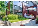 Modern exterior with wood accents, flower boxes, and concrete retaining walls at 303 Canyon Blvd # C, Boulder, CO 80302