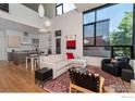 Bright living room with soaring ceilings, hardwood floors, and large windows at 303 Canyon Blvd # C, Boulder, CO 80302