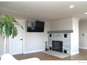 Living room featuring a modern fireplace and built-in shelving at 305 S Carr St, Lakewood, CO 80226