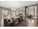 Elegant dining room with a wooden table, bench seating, and fireplace at 3183 Starry Night Loop, Castle Rock, CO 80109