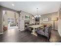 Elegant dining room with a wooden table, bench seating, and fireplace at 3183 Starry Night Loop, Castle Rock, CO 80109