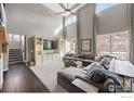 Spacious living room with a large sectional sofa, high ceilings, and ample natural light at 3183 Starry Night Loop, Castle Rock, CO 80109