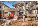 Charming two-story home featuring a bright red front door and inviting entrance at 33 Garfield St, Denver, CO 80206