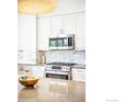 Modern kitchen details showcasing stainless steel appliances and white cabinetry at 3301 Arapahoe Ave # 117, Boulder, CO 80303