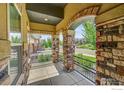 Covered porch with stone pillars and wrought iron railings at 365 Casalon Pl, Superior, CO 80027