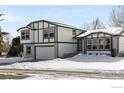 Two-story house with gray and white exterior, attached garage, and snowy front yard at 4223 Peach Way, Boulder, CO 80301