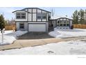 Two-story house with gray and white exterior, attached garage, and snowy front yard at 4223 Peach Way, Boulder, CO 80301