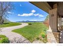 Landscaped front yard with walkway leading to home and mountain views at 5277 Westridge Dr, Boulder, CO 80301