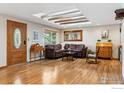 Spacious living room with hardwood floors, and skylights at 5604 Bowron Pl, Longmont, CO 80503