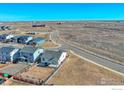 Aerial view of a house in a quiet neighborhood, backed by open land and clear sky at 6325 Copper Dr, Erie, CO 80516