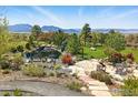 Backyard featuring a pond, a stone patio with outdoor seating and mountain views at 635 Paragon Dr, Boulder, CO 80303