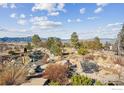 Outdoor seating area with mountain views, surrounded by lush landscaping and a koi pond at 635 Paragon Dr, Boulder, CO 80303