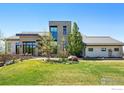 Beautiful home featuring modern architecture, a well manicured lawn, and stylish landscaping at 635 Paragon Dr, Boulder, CO 80303