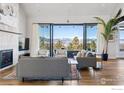 Elegant living room featuring large windows, a fireplace, and mountain views at 635 Paragon Dr, Boulder, CO 80303