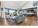 Open-concept living space with vaulted ceilings, mountain views, and a modern kitchen at 635 Paragon Dr, Boulder, CO 80303