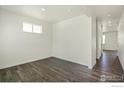 Spacious living room with dark wood floors and an open floorplan at 6530 13Th St, Frederick, CO 80530