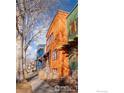 Street view of the colorful modern townhomes featuring sidewalks and trees at 820 Tenacity Dr, Longmont, CO 80504