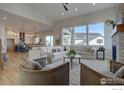 Open floor plan living room with sectional sofa, hardwood floors, and fireplace at 904 Eldorado Ln, Louisville, CO 80027