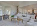 Spacious living room with sectional sofa, coffee table, and large windows at 904 Eldorado Ln, Louisville, CO 80027