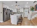 This modern kitchen is complete with stainless steel appliances, a kitchen island, and hardwood floors at 1055 Jade St, Broomfield, CO 80020