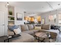 Spacious living room with L-shaped sofa and modern coffee table at 11310 Colony Cir, Broomfield, CO 80021