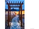 Welcoming walkway leading to the front door, framed by a lovely pergola at 14117 W 58Th Pl, Arvada, CO 80004