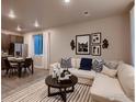 Open living room with L-shaped sofa, coffee table, and adjacent dining area at 1434 Coral Pl, Longmont, CO 80504