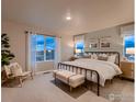 Spacious main bedroom with a large bed, chair, and window views at 1438 Coral Pl, Longmont, CO 80504