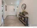 Bright entryway with wood-look floors and a console table at 14703 Guernsey Dr, Mead, CO 80542