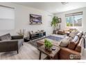 Spacious living room featuring a brown leather sectional sofa and a large TV at 14703 Guernsey Dr, Mead, CO 80542