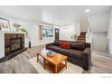 Comfortable living room with a modern fireplace, hardwood floors, and natural light at 1521 Bradley Dr, Boulder, CO 80305