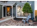 Inviting front entry with a sunroom and stone walkway at 194 W Sycamore Ln, Louisville, CO 80027